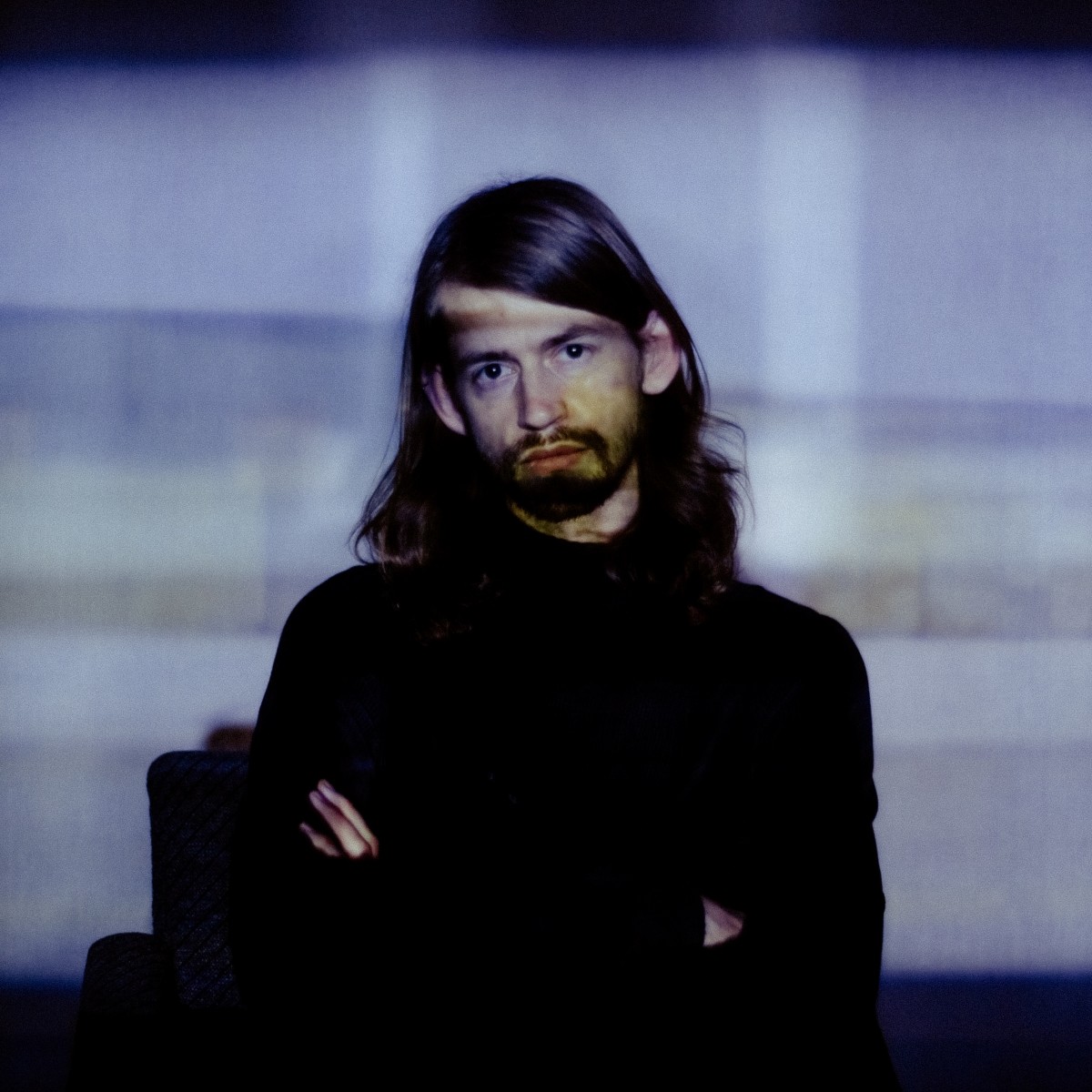 Artist Paul Sutherland in front of projection